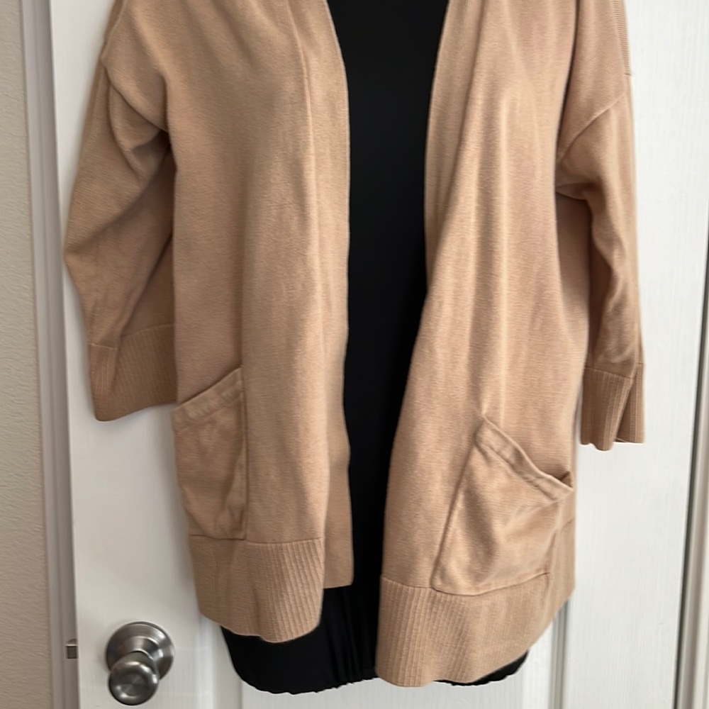 Cardigan Sweater.  3/4 sleeves and pockets.  Open, no buttons.
